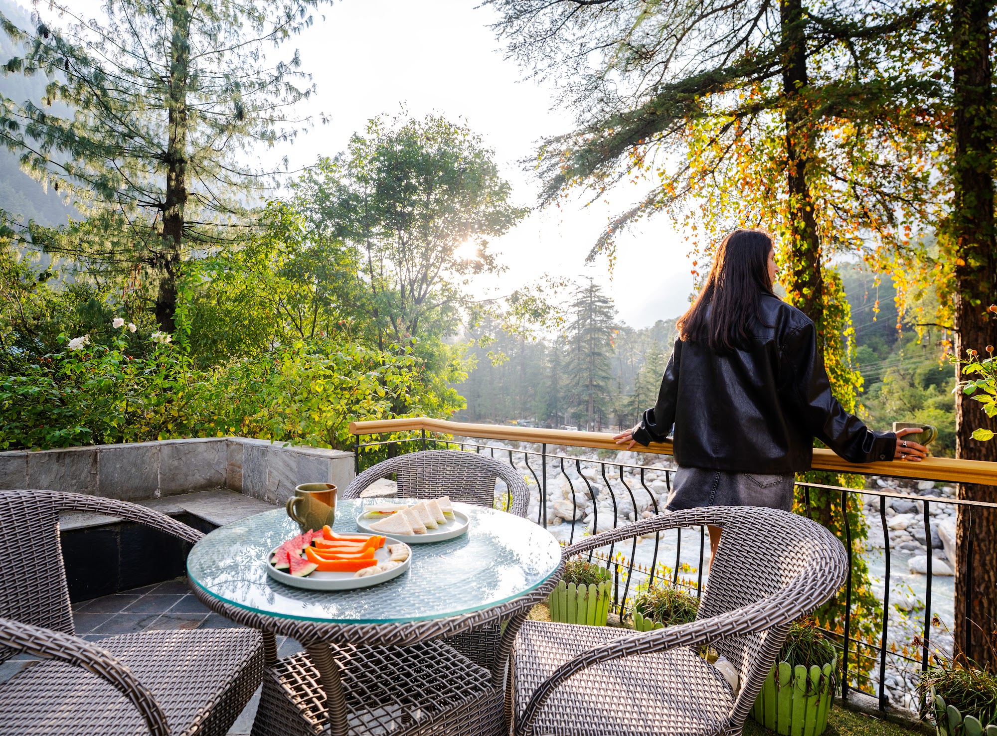 Guest on the first-floor balcony looking out over the trees