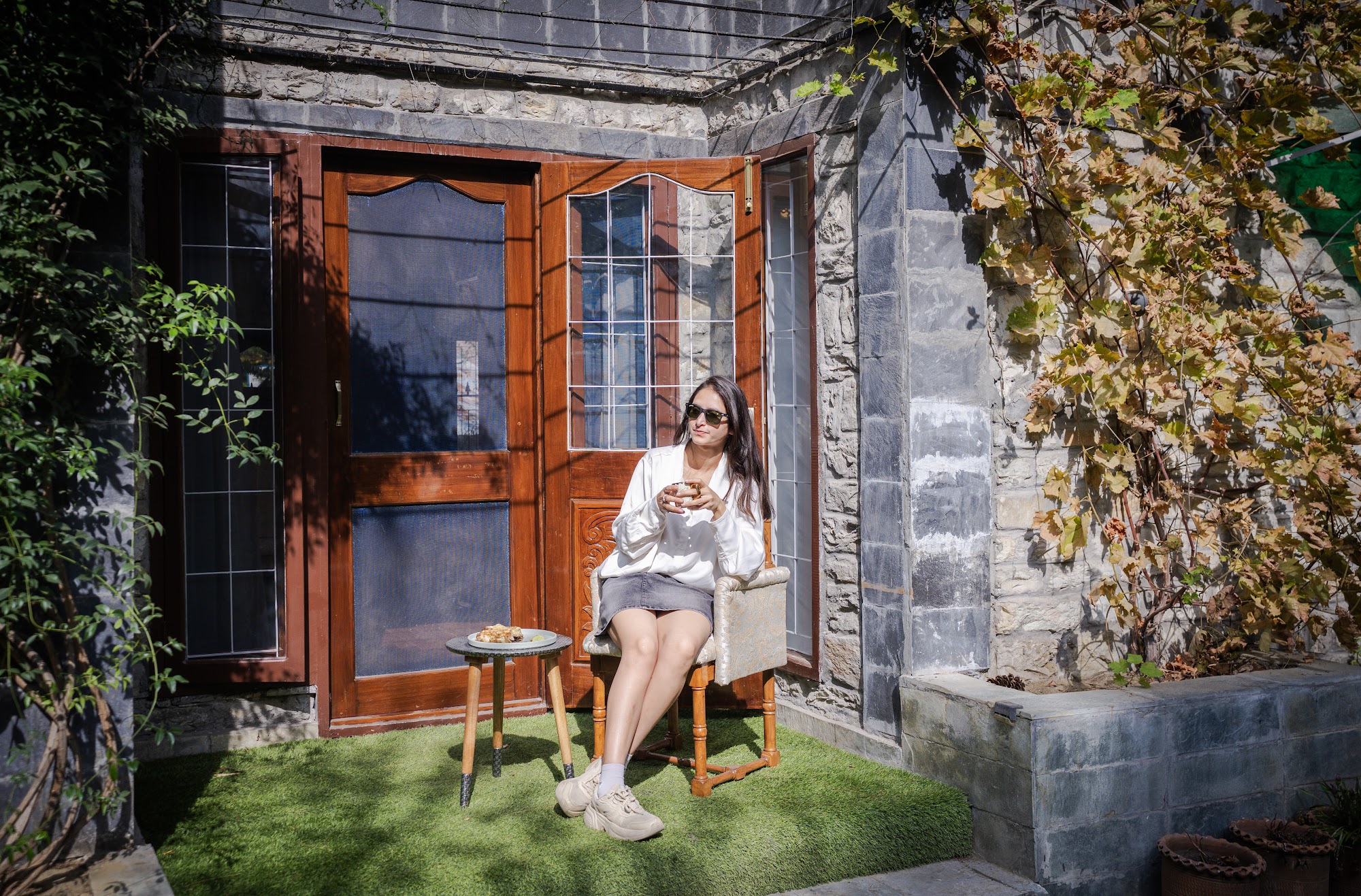 Private courtyard outside the ground-floor suite, with stone walls and wooden windows