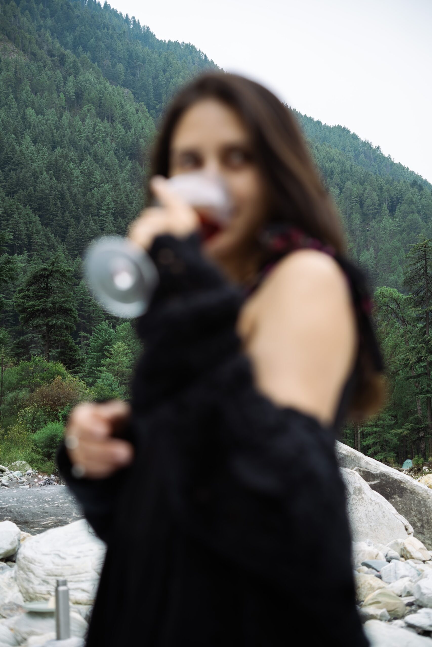 Guest at a riverside picnic with mountains behind